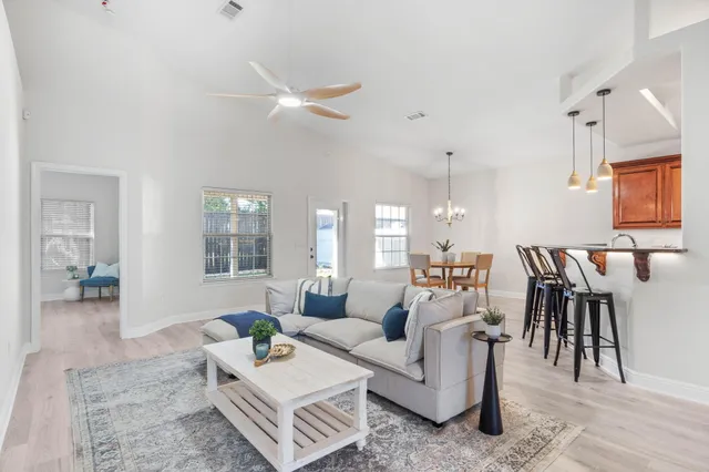 a living room with furniture a rug and a chandelier