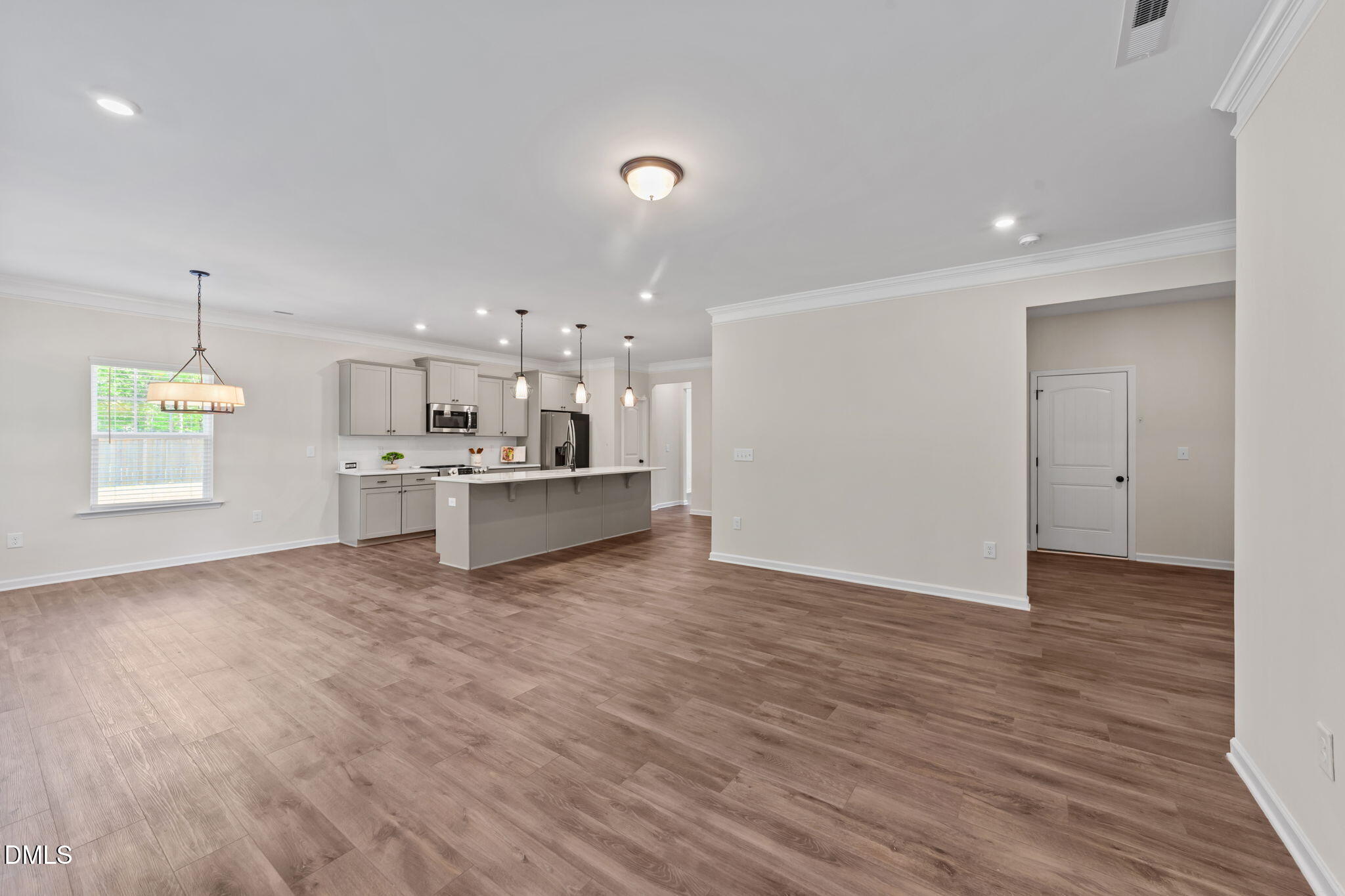 3901 Bluffwind Drive Raleigh, NC 27603 - Photo 13 of 42 a view of an empty room with kitchen and window