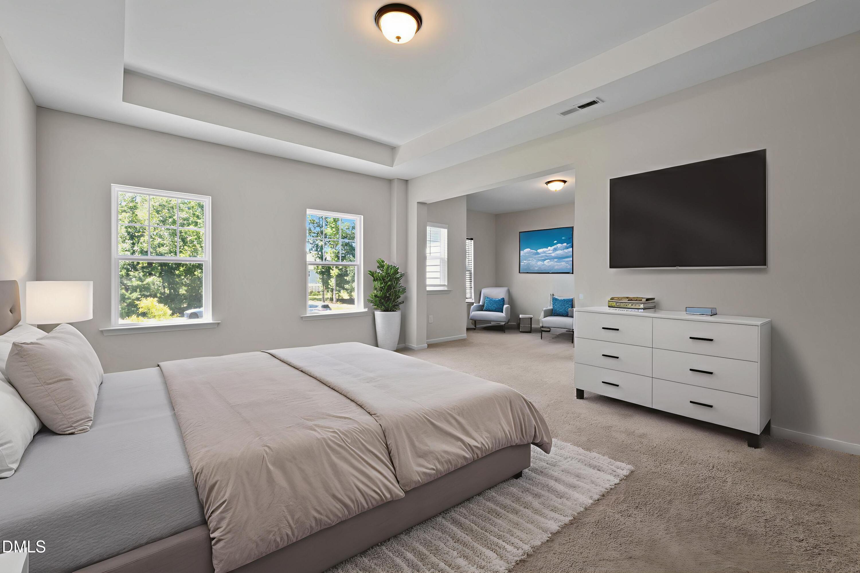 3901 Bluffwind Drive Raleigh, NC 27603 - Photo 17 of 42 a bedroom with a bed and a flat screen tv