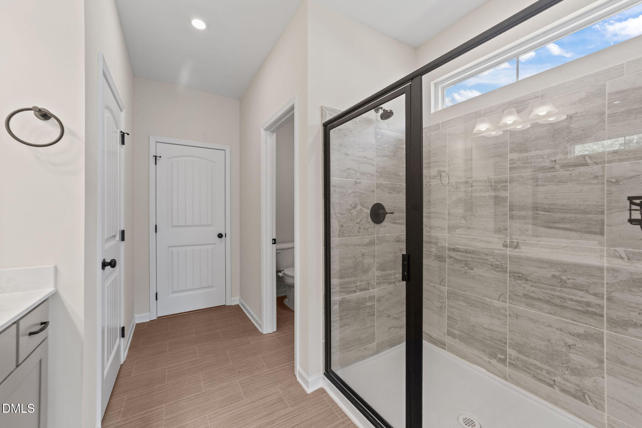 3901 Bluffwind Drive Raleigh, NC 27603 - Photo 20 of 42 a bathroom with a glass shower door