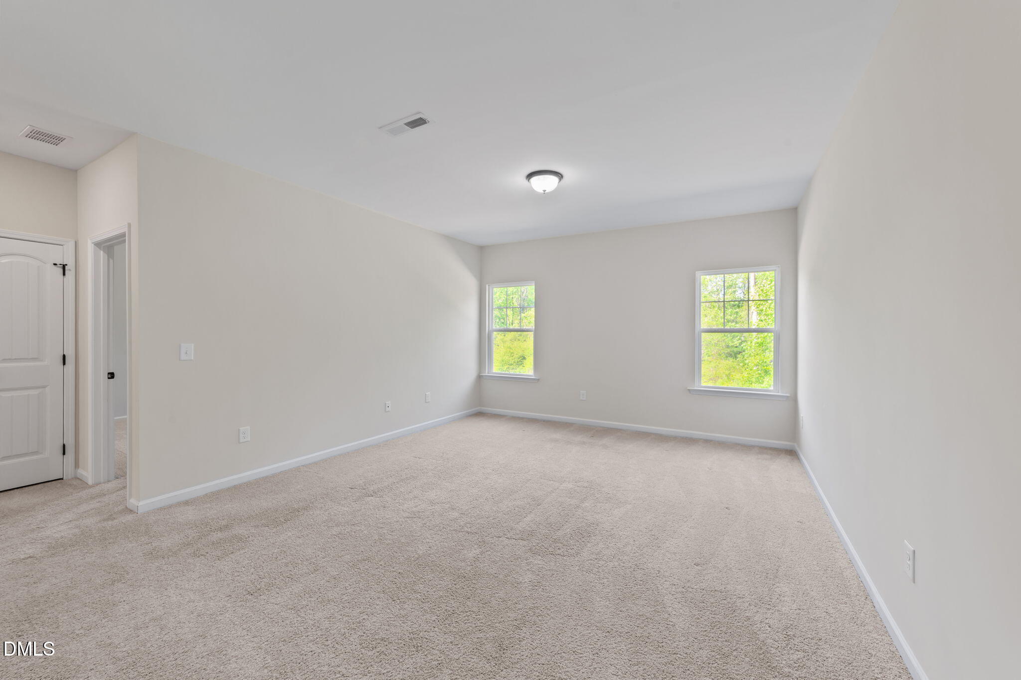 3901 Bluffwind Drive Raleigh, NC 27603 - Photo 22 of 42 a view of an empty room with a window and a kitchen