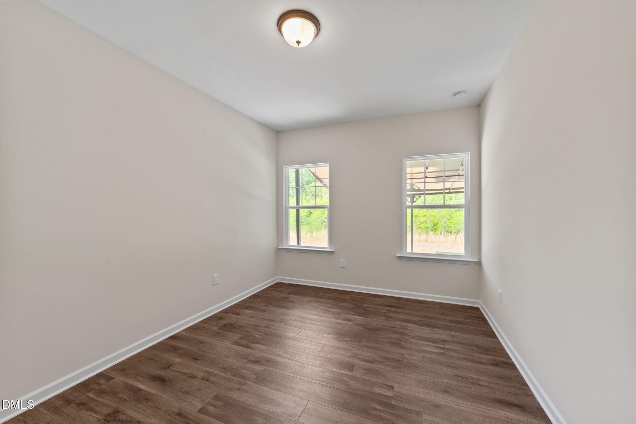 3901 Bluffwind Drive Raleigh, NC 27603 - Photo 31 of 42 an empty room with wooden floor and windows