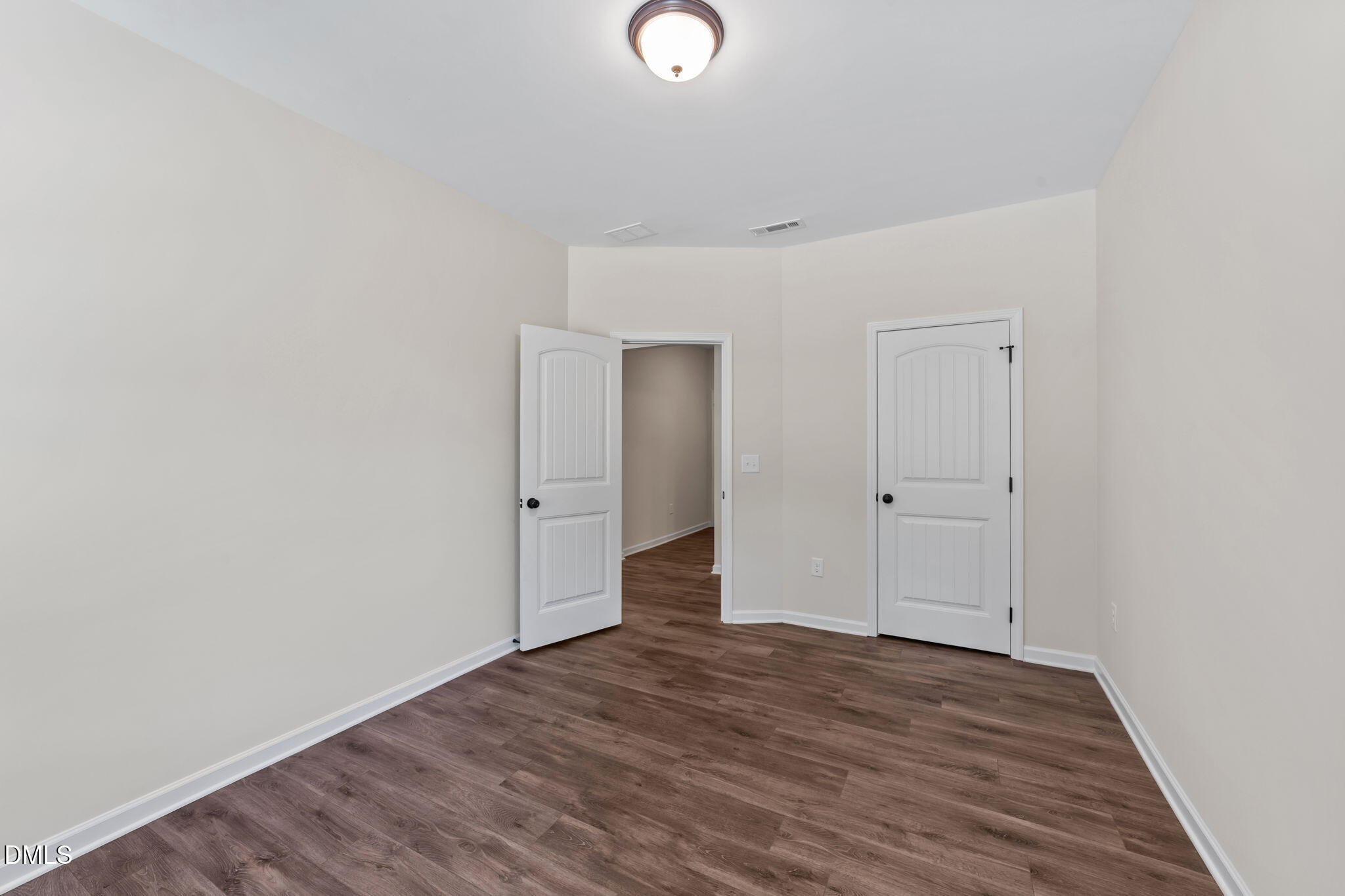 3901 Bluffwind Drive Raleigh, NC 27603 - Photo 32 of 42 a view of an empty room with wooden floor and closet