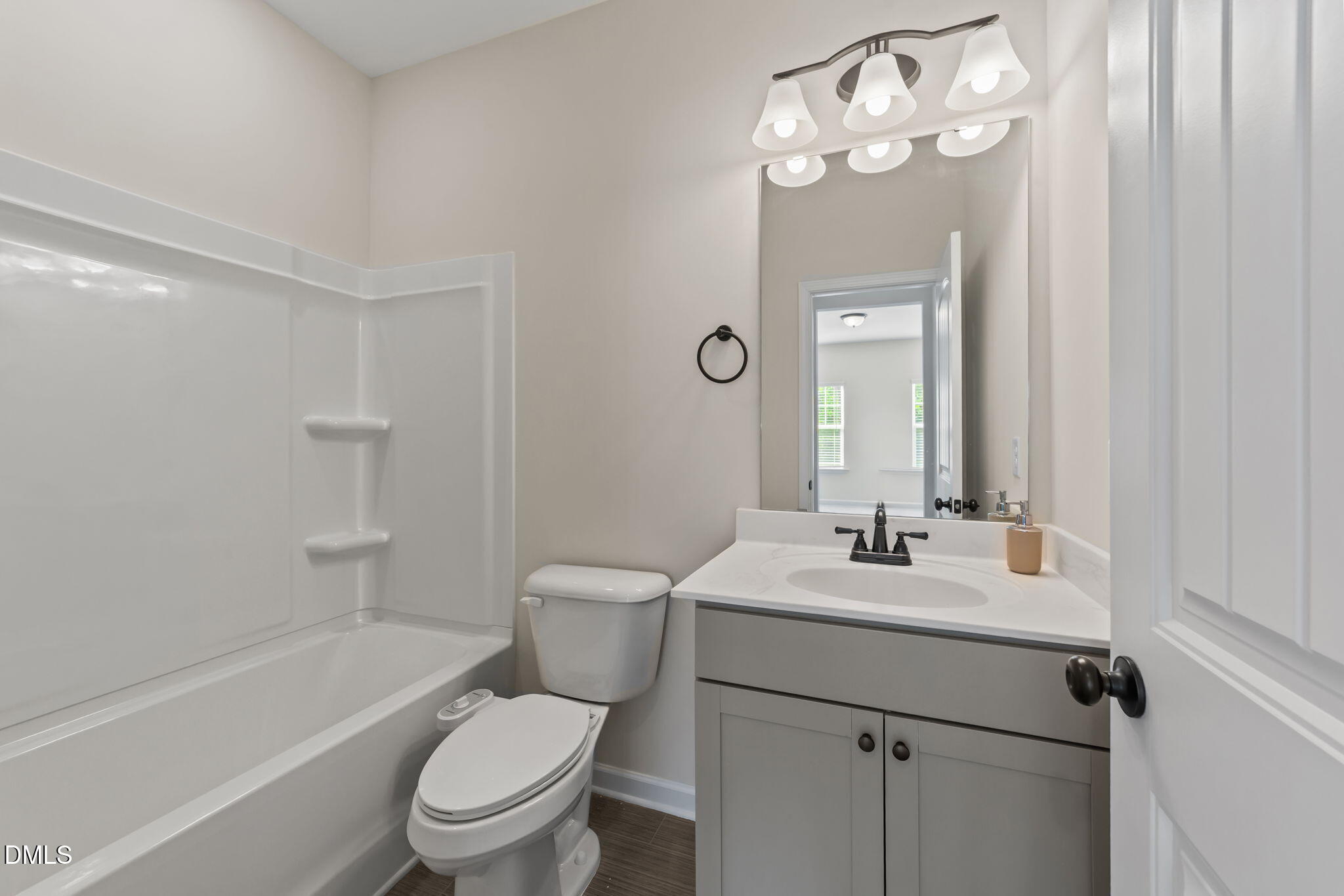 3901 Bluffwind Drive Raleigh, NC 27603 - Photo 33 of 42 a bathroom with a sink a toilet a mirror and shower