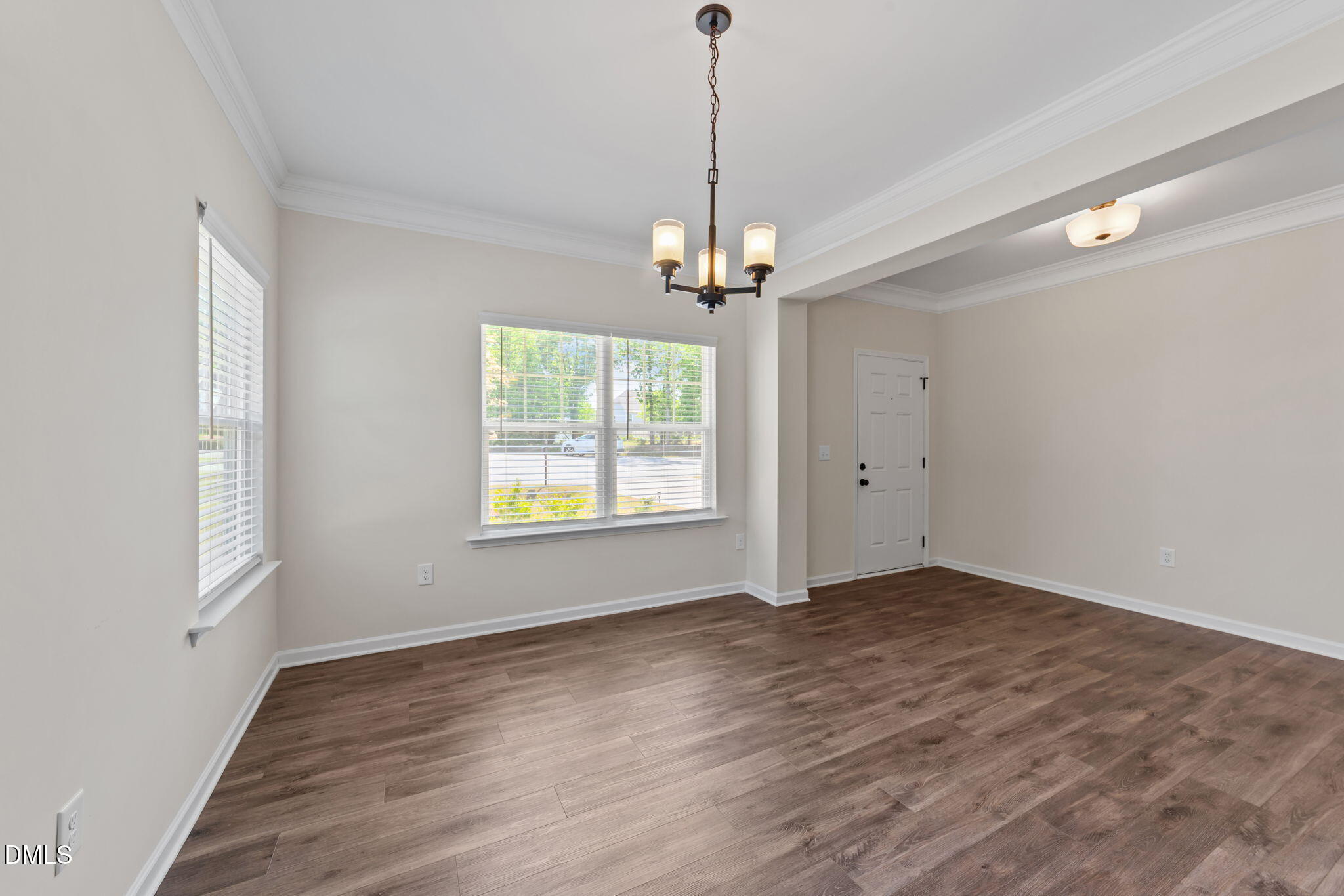 3901 Bluffwind Drive Raleigh, NC 27603 - Photo 4 of 42 a view of a room with wooden floor a ceiling fan and windows