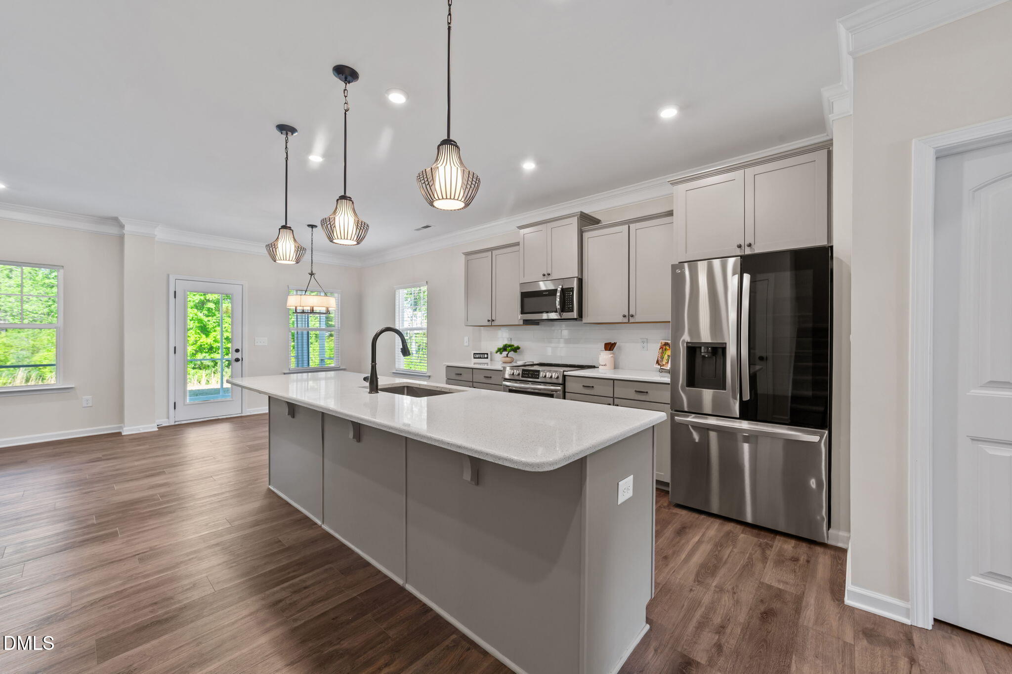 3901 Bluffwind Drive Raleigh, NC 27603 - Photo 7 of 42 a large kitchen with stainless steel appliances lots of counter space and wooden floor