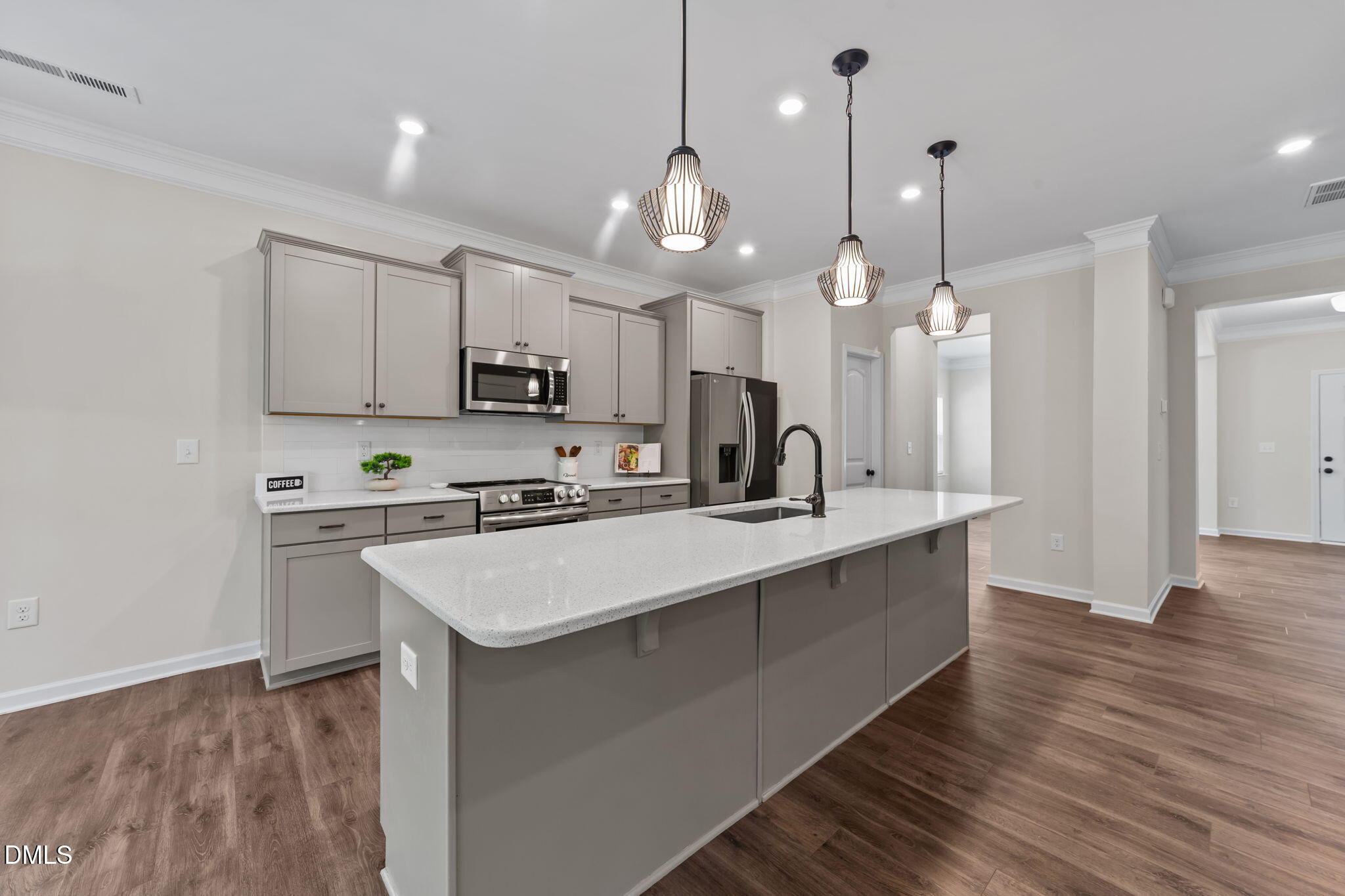 3901 Bluffwind Drive Raleigh, NC 27603 - Photo 8 of 42 a large kitchen with stainless steel appliances kitchen island a large island in the center