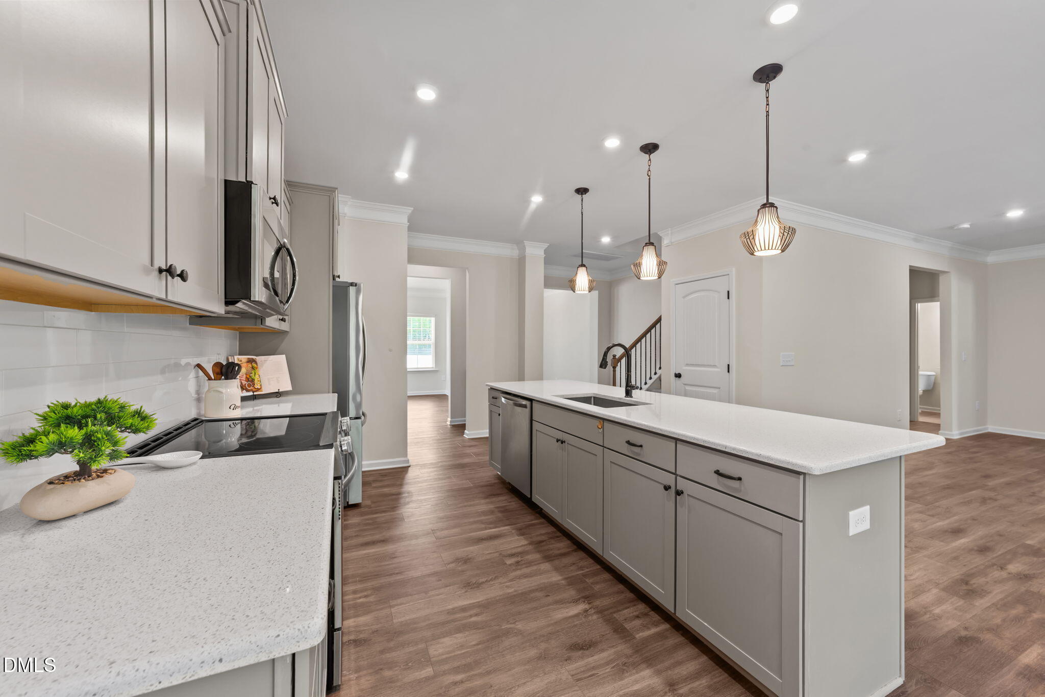 3901 Bluffwind Drive Raleigh, NC 27603 - Photo 9 of 42 a large kitchen with stainless steel appliances kitchen island a large counter top a sink a stove and a refrigerator