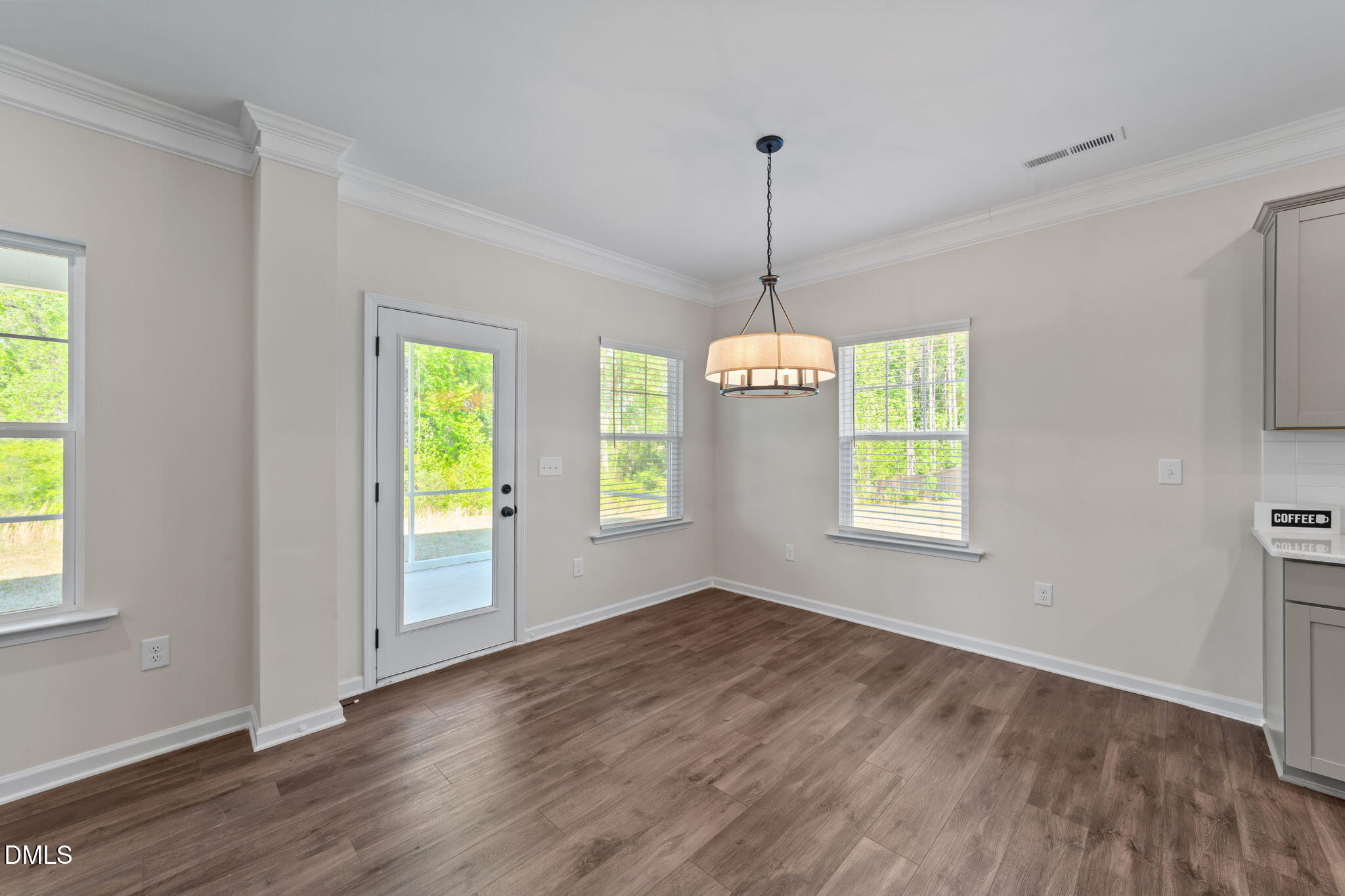 3901 Bluffwind Drive Raleigh, NC 27603 - Photo 10 of 42 a view of an empty room with window and wooden floor