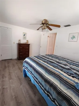 a bedroom with a bed and cabinets