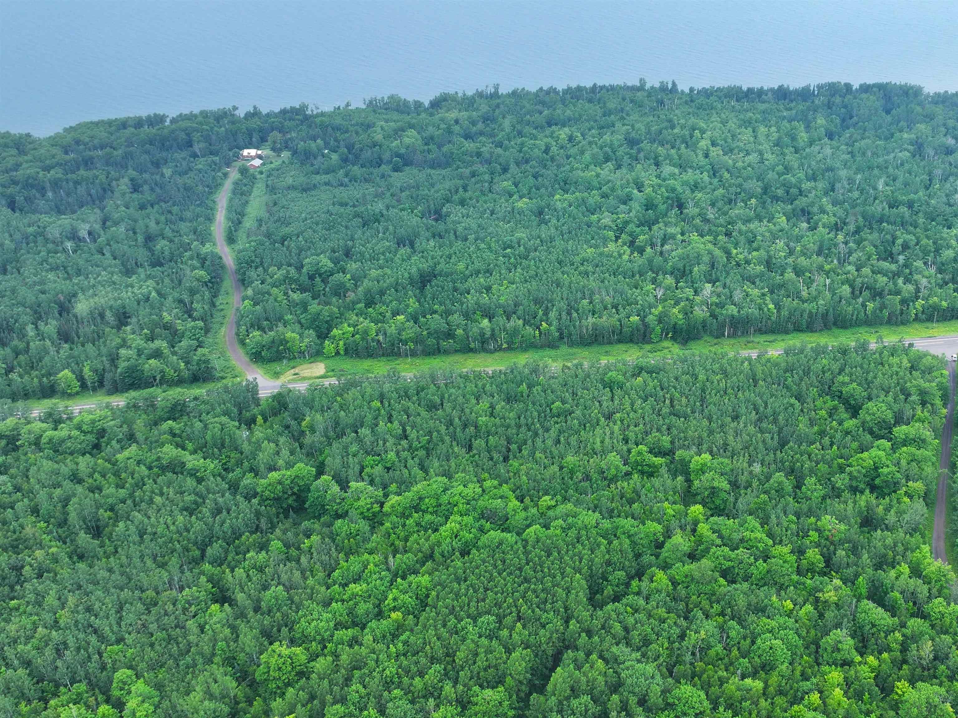 13 State Highway 13 Port Wing, WI 54865 - Photo 3 of 13 Aerial view of property and surrounding area with a heavily wooded area