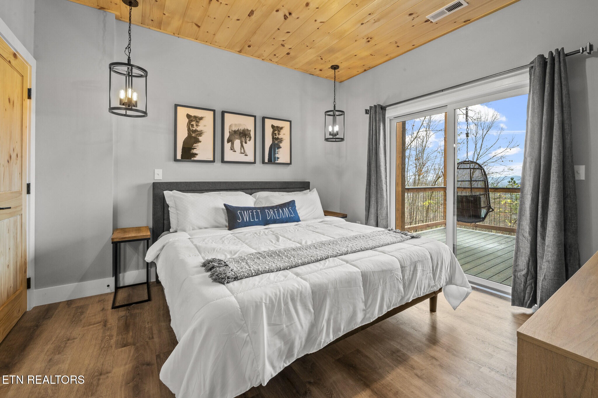 688 Shell Mountain Road Sevierville, TN 37876 - Photo 30 of 43 a bedroom with a large bed and a large window