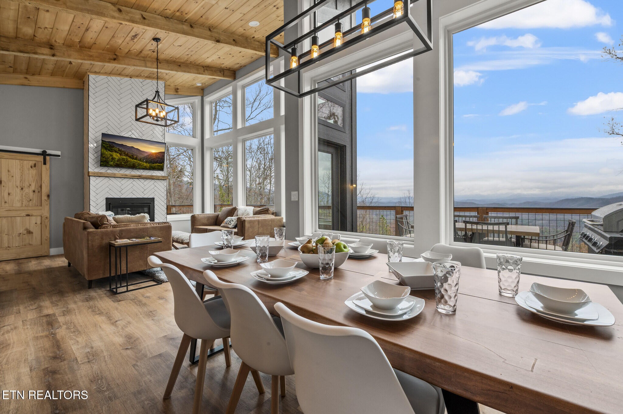 688 Shell Mountain Road Sevierville, TN 37876 - Photo 3 of 43 a dining room with furniture a large window and a rug