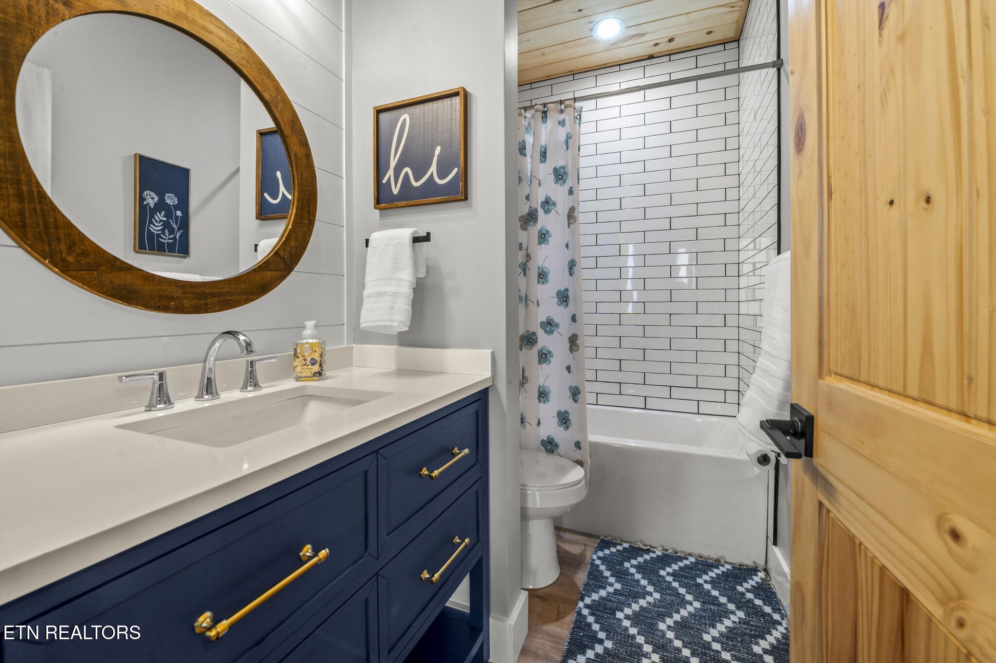 688 Shell Mountain Road Sevierville, TN 37876 - Photo 35 of 43 a bathroom with a sink a toilet and a mirror