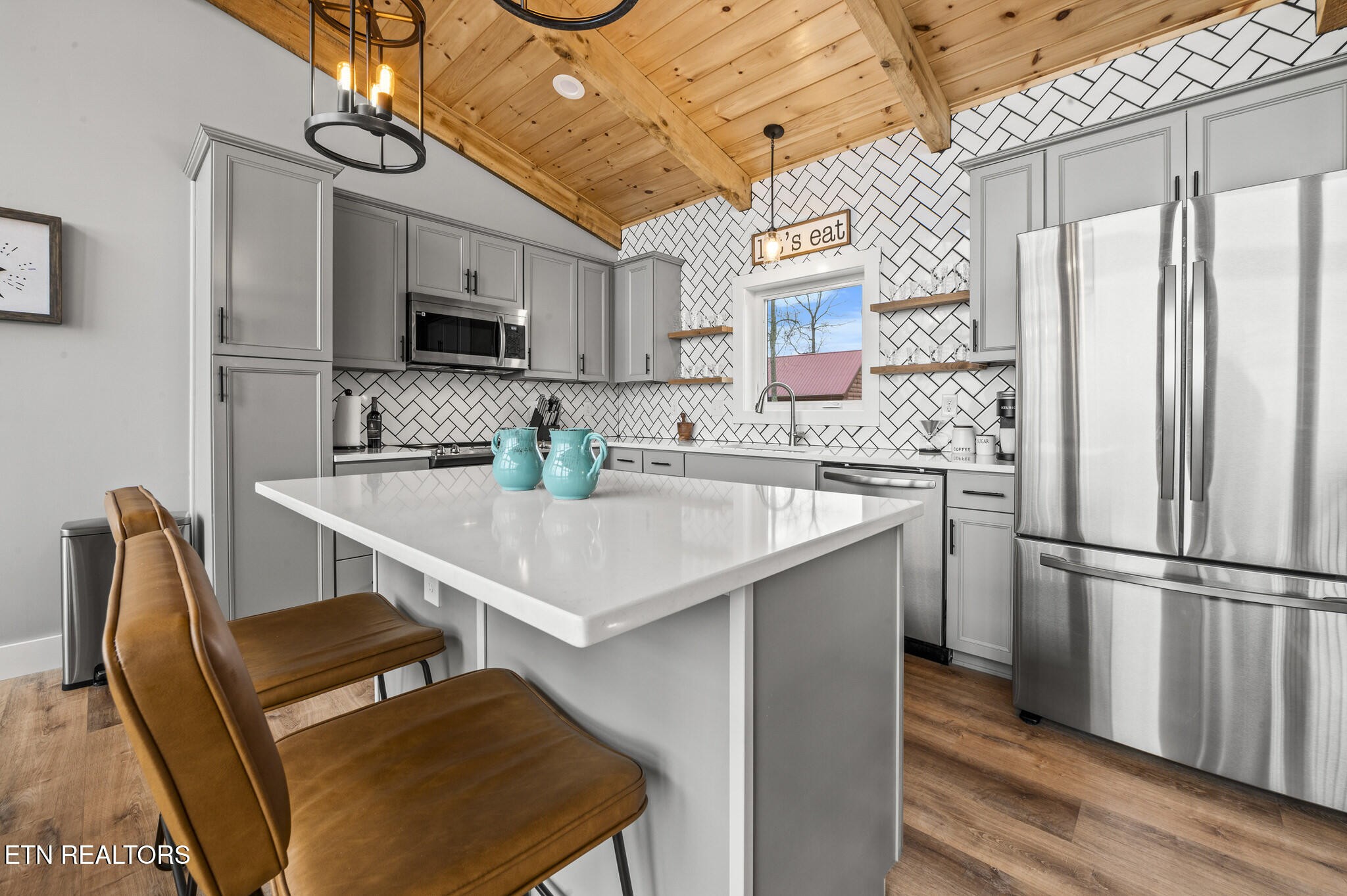 688 Shell Mountain Road Sevierville, TN 37876 - Photo 4 of 43 a kitchen with stainless steel appliances a microwave a sink and a refrigerator