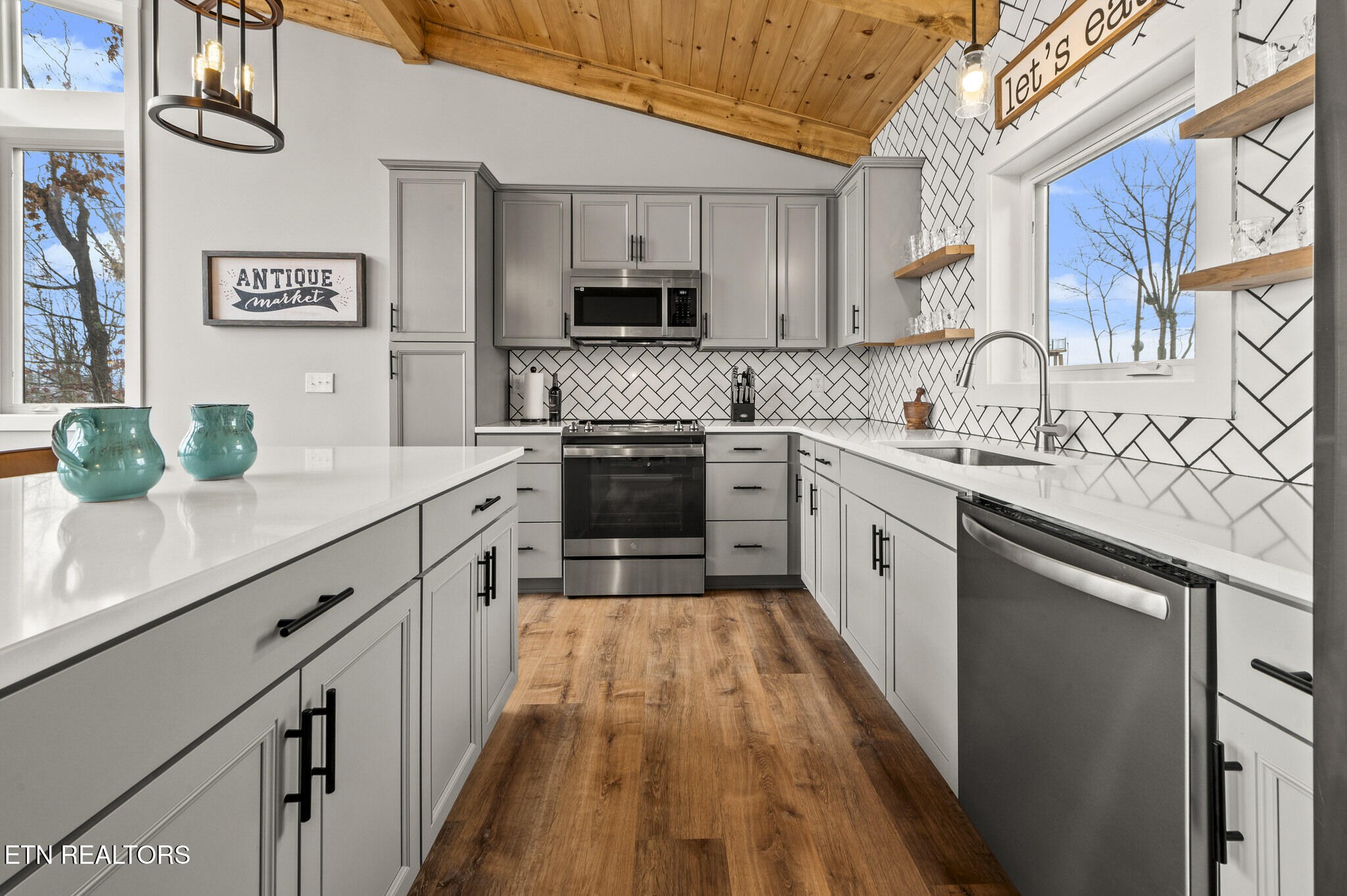 688 Shell Mountain Road Sevierville, TN 37876 - Photo 10 of 43 a white kitchen with stainless steel appliances granite countertop lots of counter top space and a sink