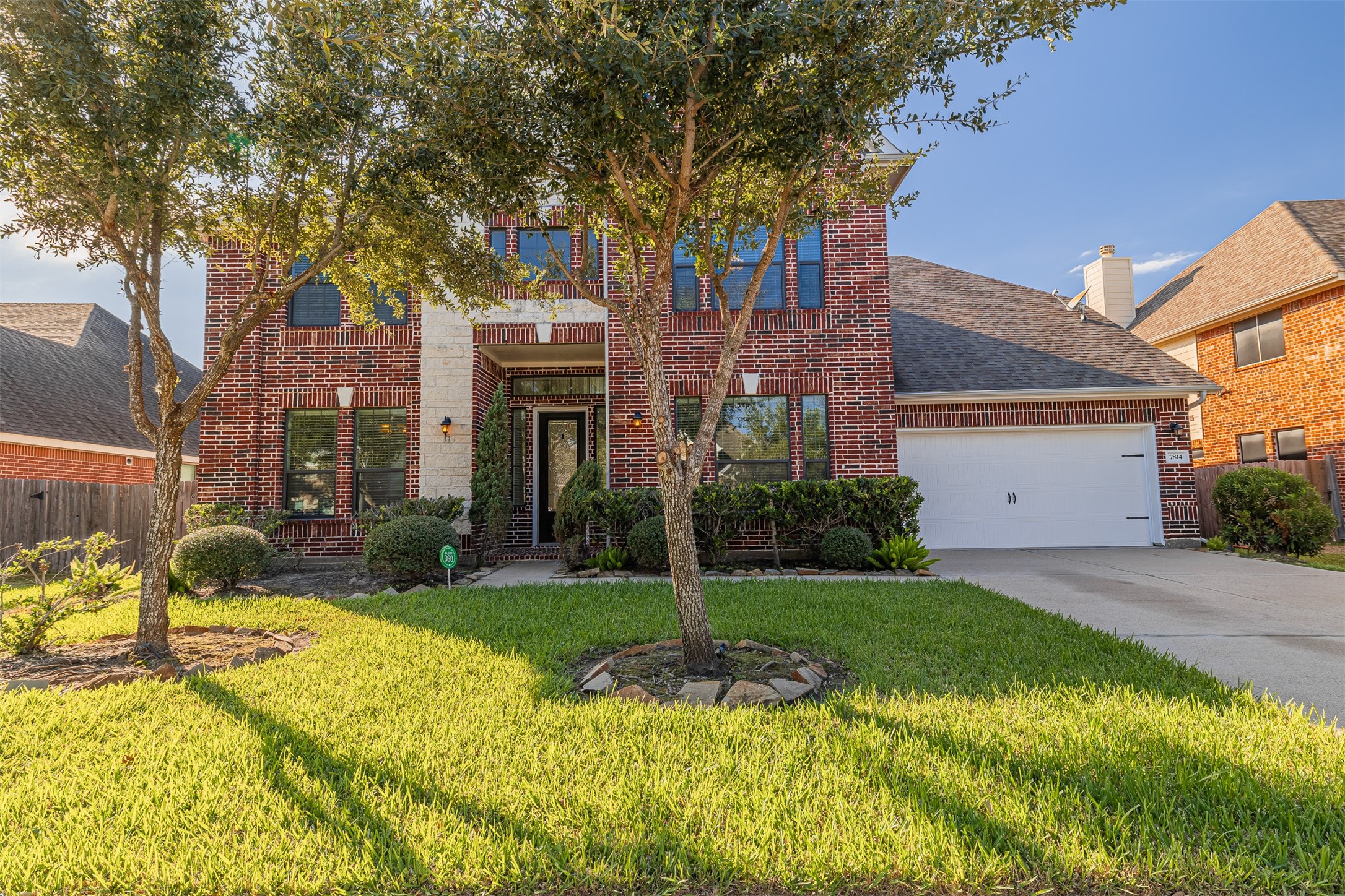 7814 Pacific Spring Lane Richmond, TX 77407 - Photo 1 of 32 a front view of a house with garden