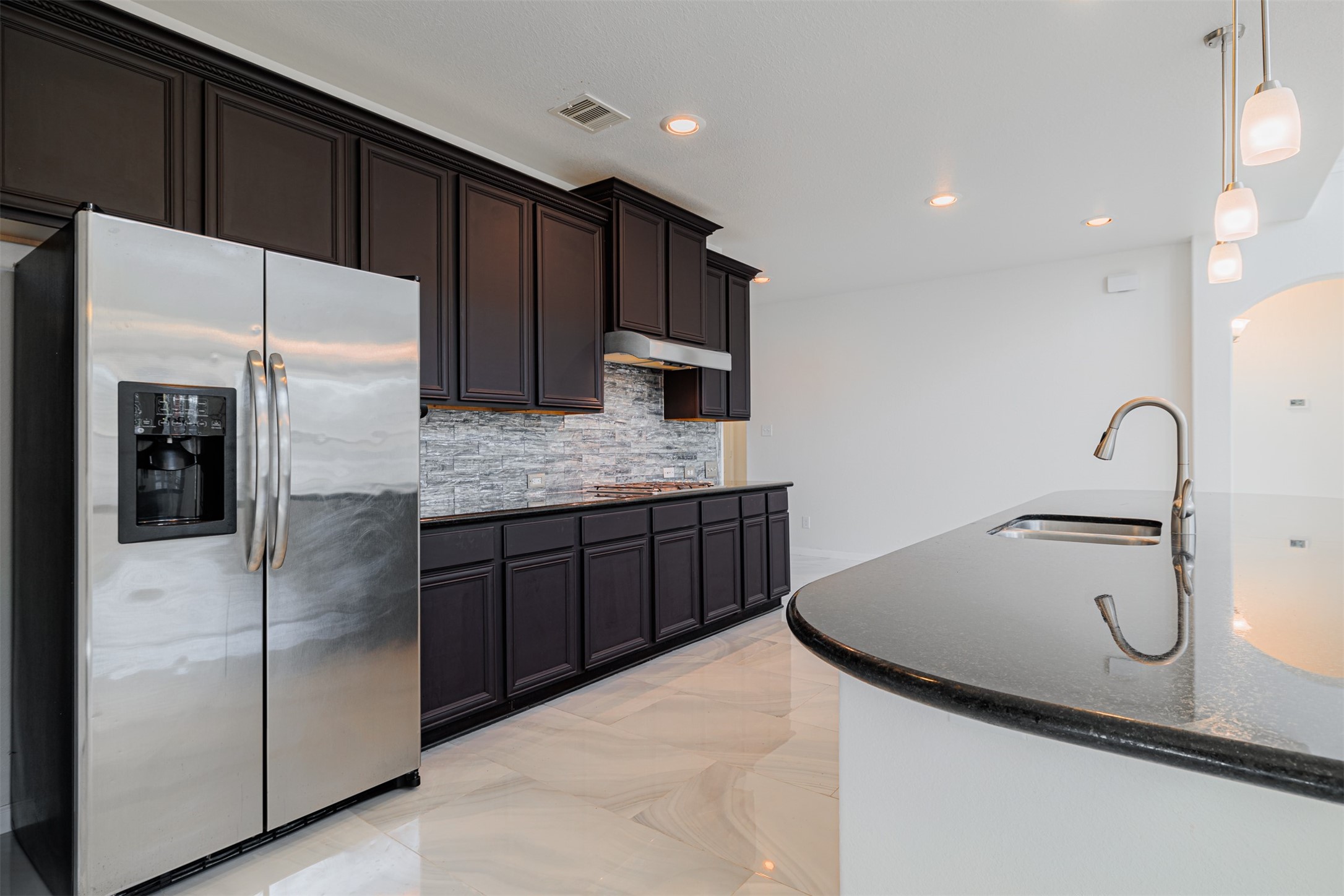 7814 Pacific Spring Lane Richmond, TX 77407 - Photo 12 of 32 a kitchen with stainless steel appliances granite countertop a refrigerator and a sink
