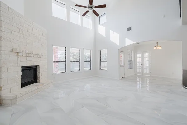 a view of a livingroom with a fireplace and window