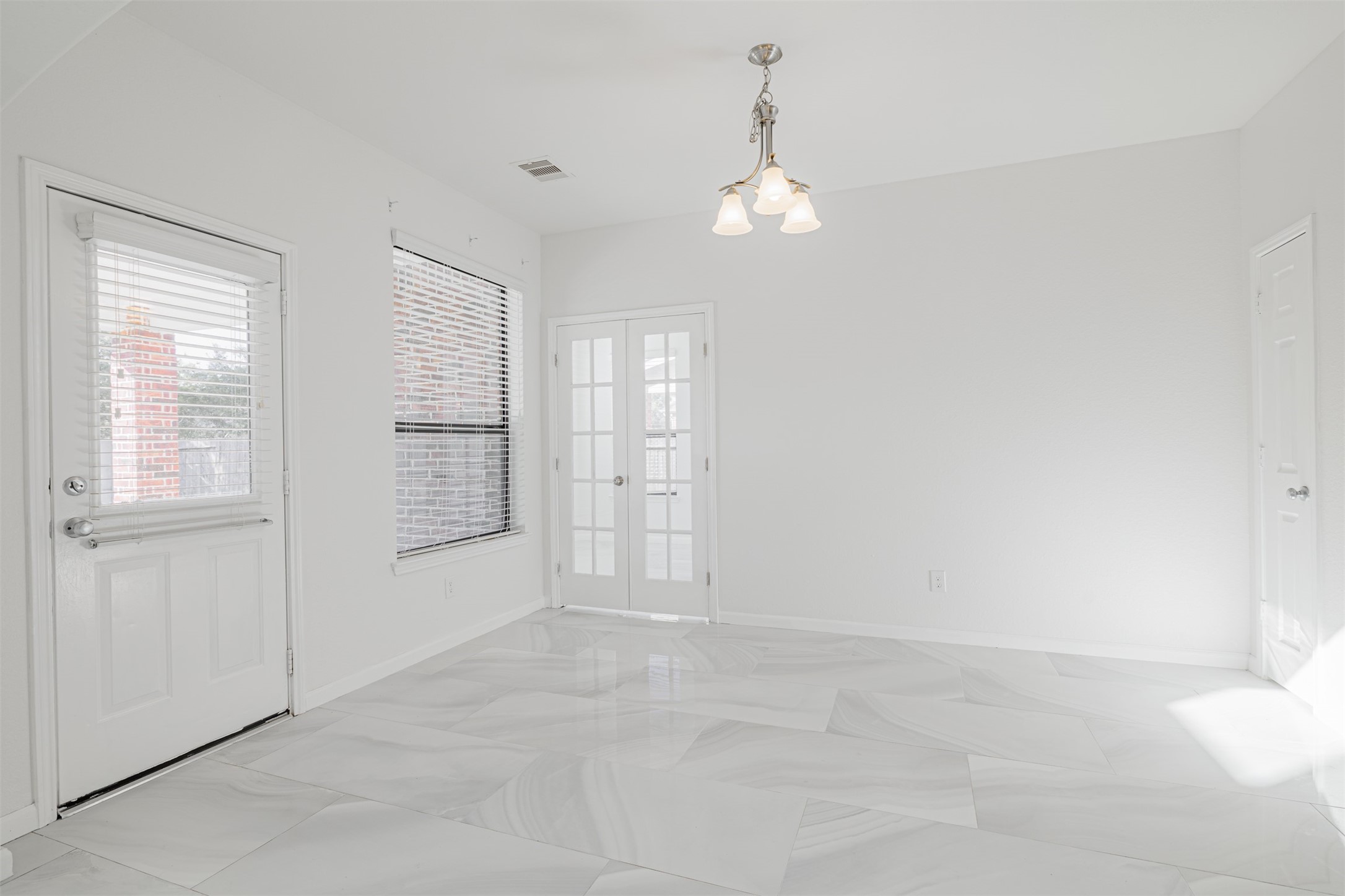 7814 Pacific Spring Lane Richmond, TX 77407 - Photo 16 of 32 an empty room with chandelier fan