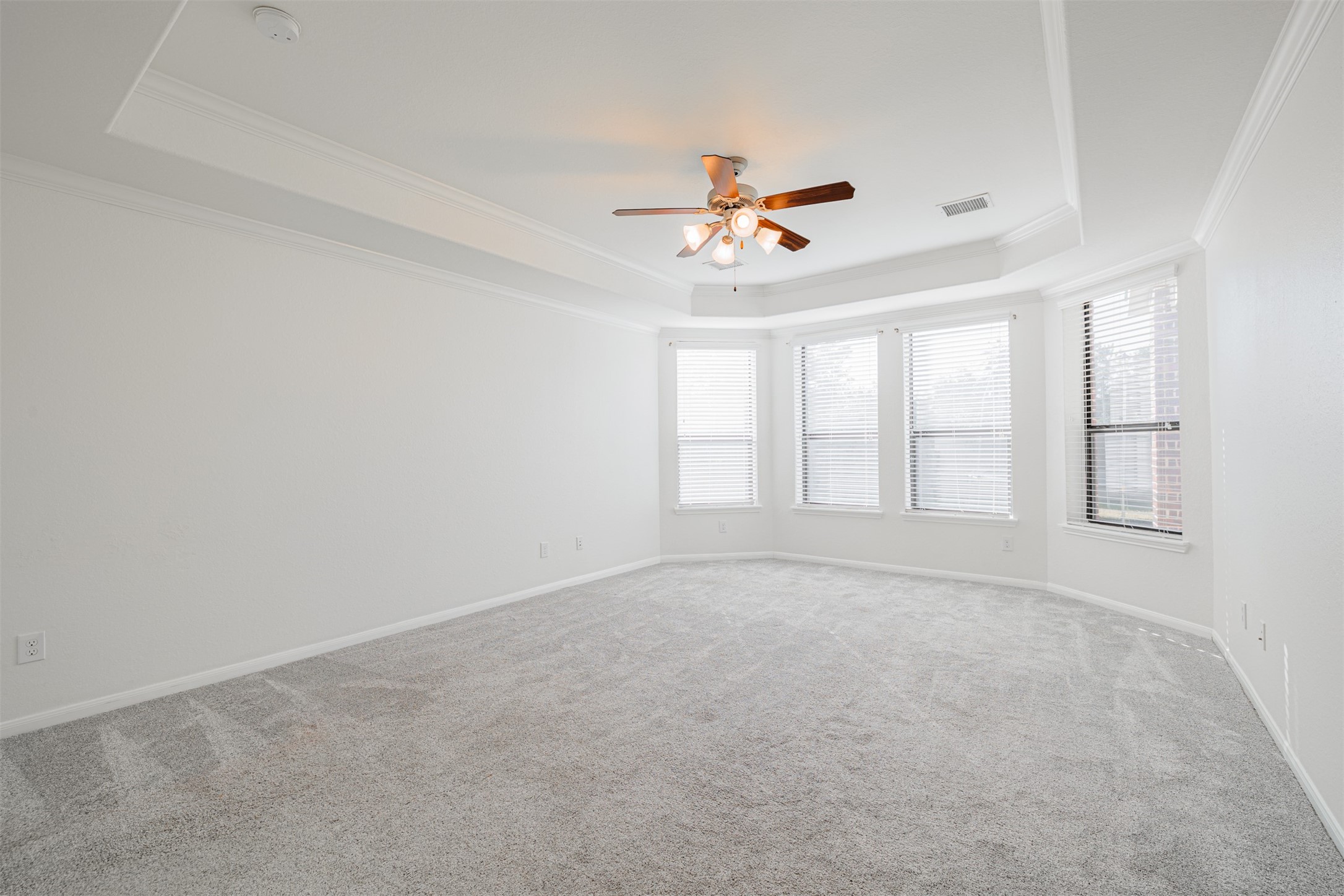 7814 Pacific Spring Lane Richmond, TX 77407 - Photo 18 of 32 wooden floor in an empty room with a window