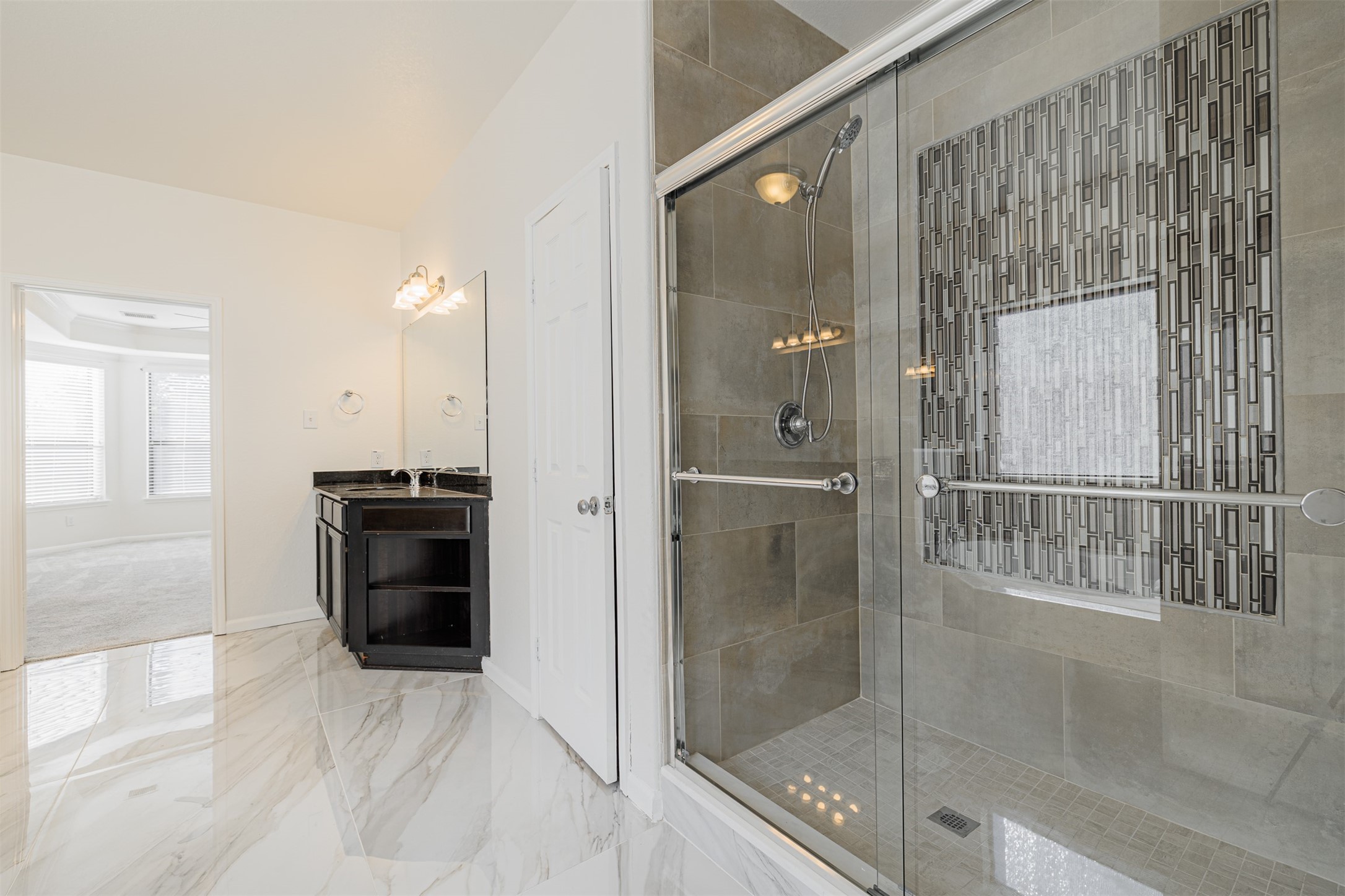 7814 Pacific Spring Lane Richmond, TX 77407 - Photo 21 of 32 a bathroom with a tub and shower