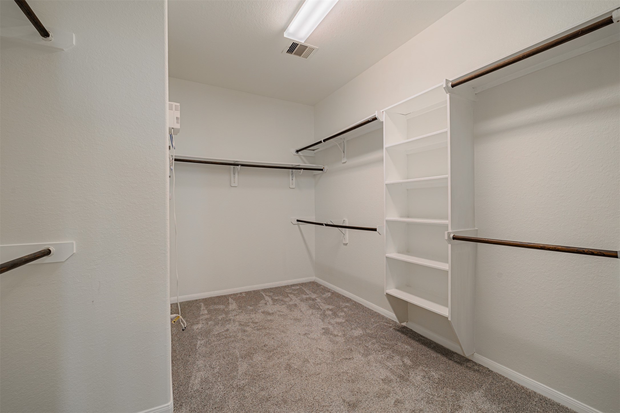 7814 Pacific Spring Lane Richmond, TX 77407 - Photo 22 of 32 a view of a walk in closet
