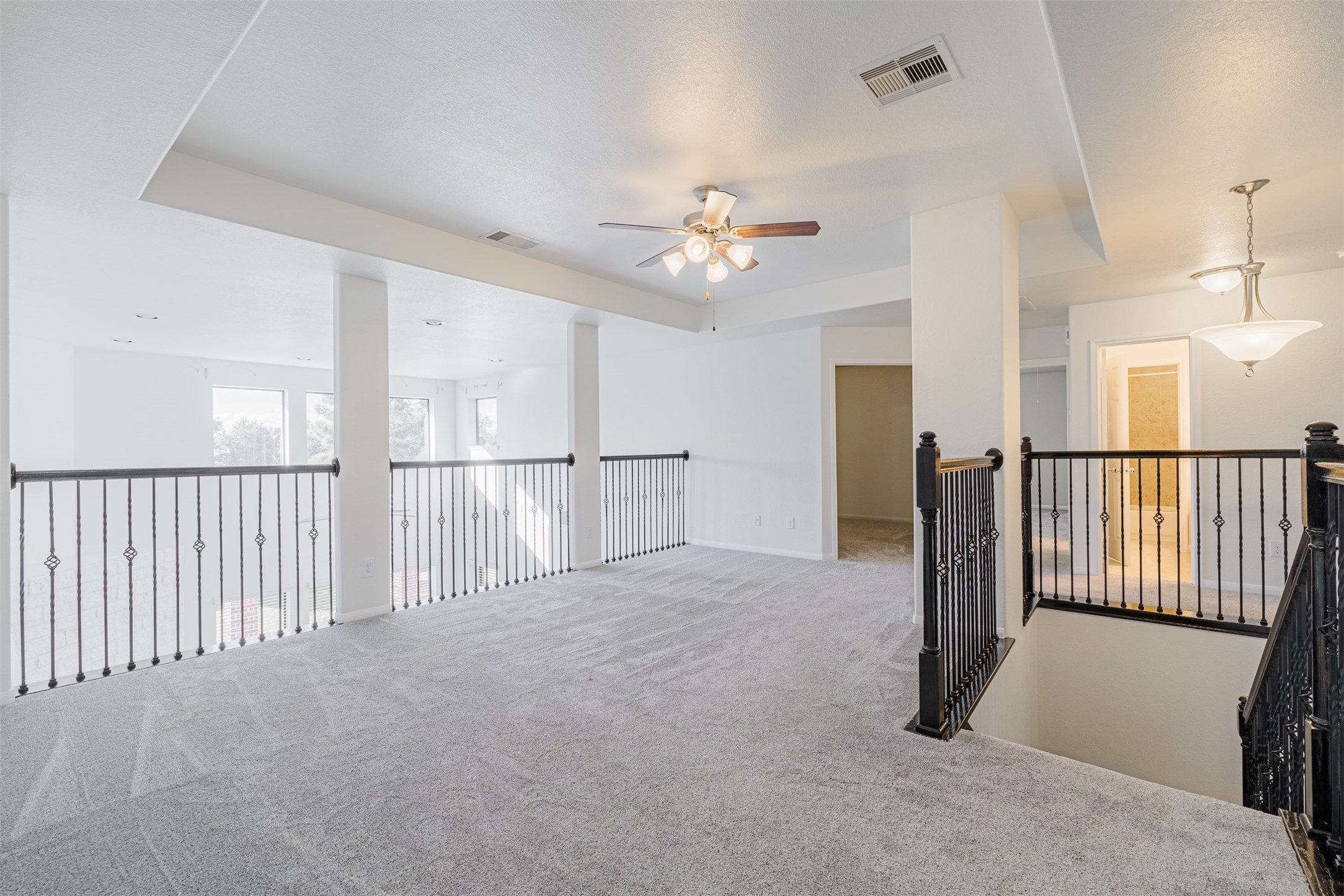 7814 Pacific Spring Lane Richmond, TX 77407 - Photo 23 of 32 a view of a hallway with a chandelier fan