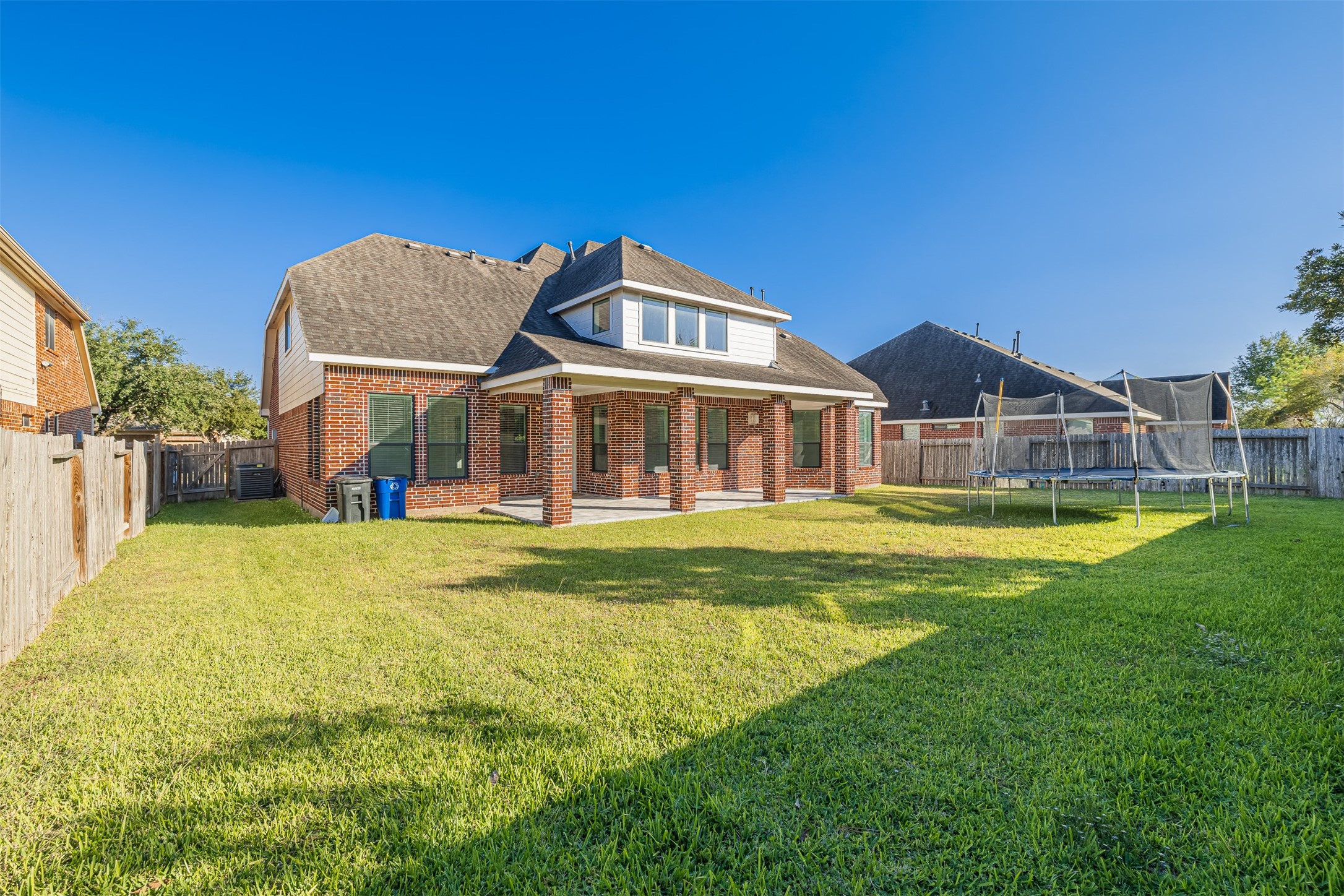 7814 Pacific Spring Lane Richmond, TX 77407 - Photo 32 of 32 a view of a house with a swimming pool