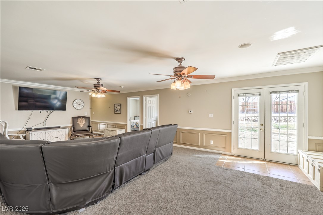 3192 North Taylor Street Logandale, NV 89021 - Photo 20 of 36 Carpeted living room featuring french doors, ceiling fan, and ornamental molding