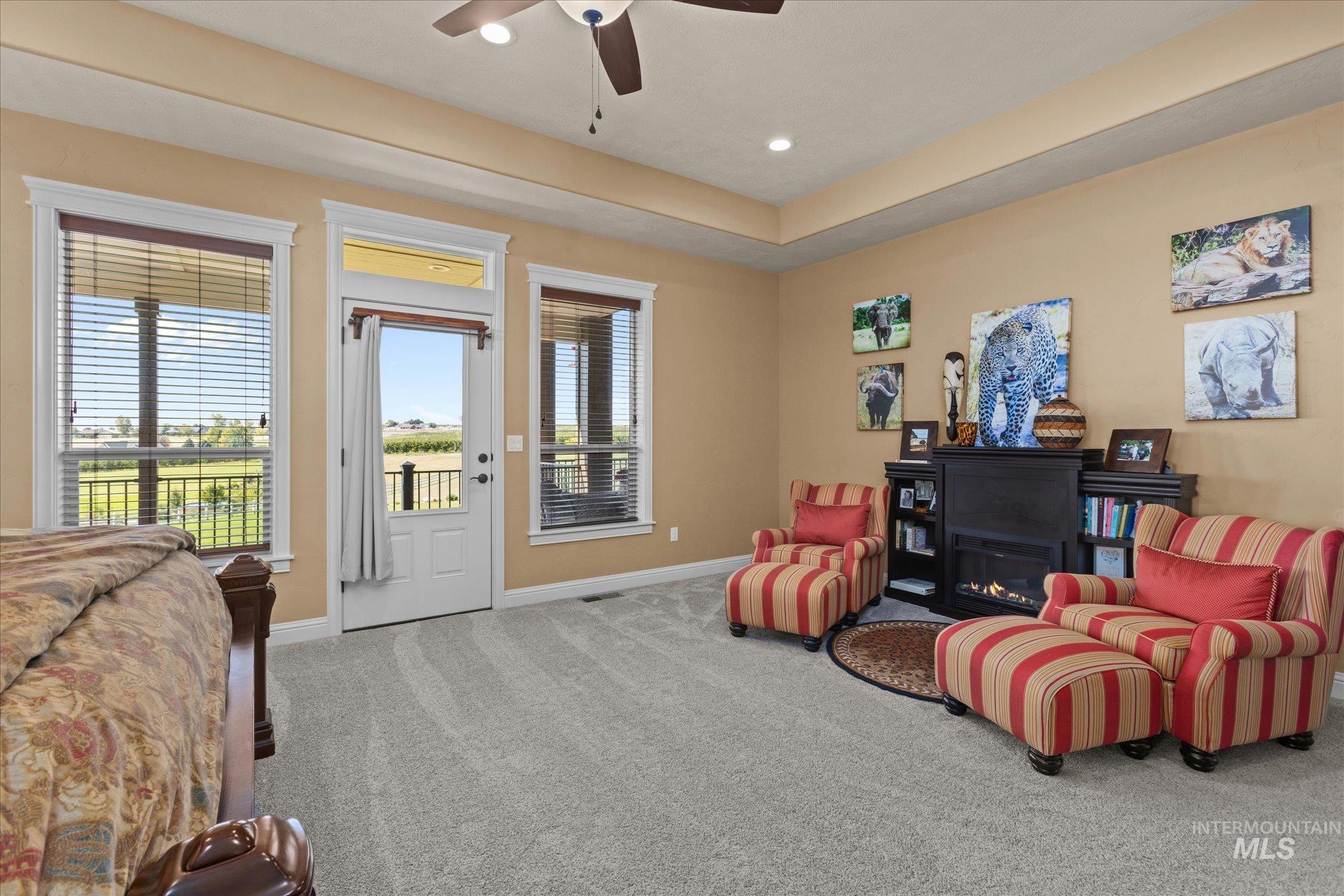 13683 Hockberger Ranch Road Caldwell, ID 83607 - Photo 21 of 50 Recessed lighting, ceiling fan, tray ceiling, built-in electric fireplace, and carpeting