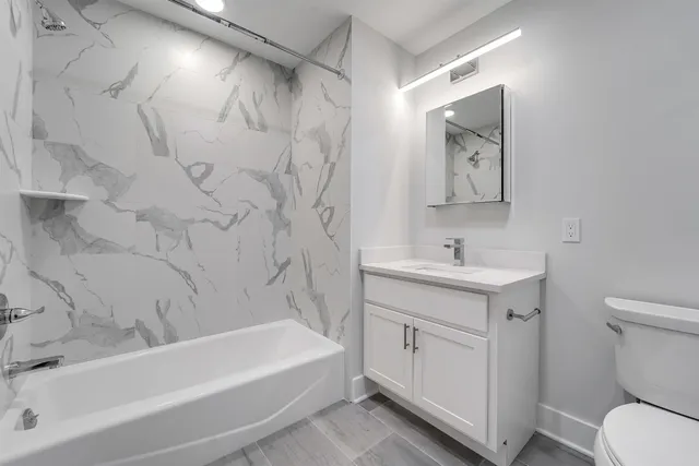 a bathroom with a sink a toilet and a bathtub