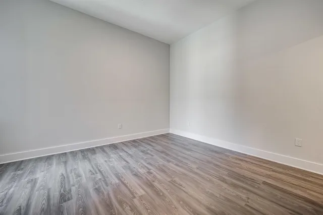 a view of an empty room and wooden floor