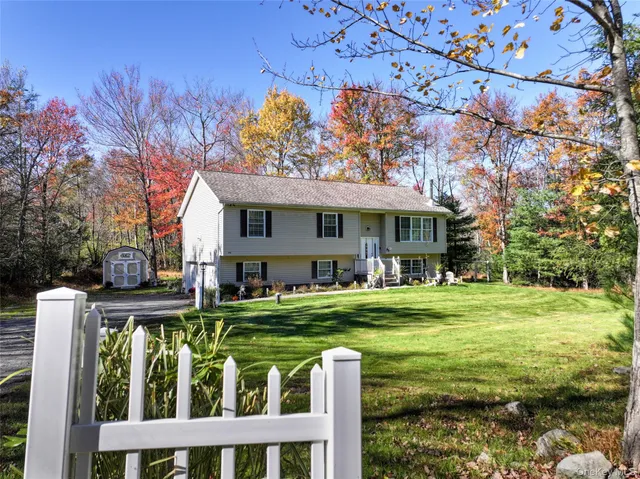 a front view of a house with a yard table and chairs