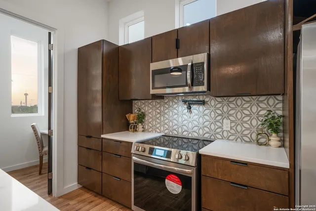 a kitchen with stainless steel appliances wooden cabinets and a sink