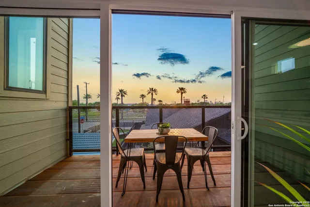 a view of a balcony dining table and chairs