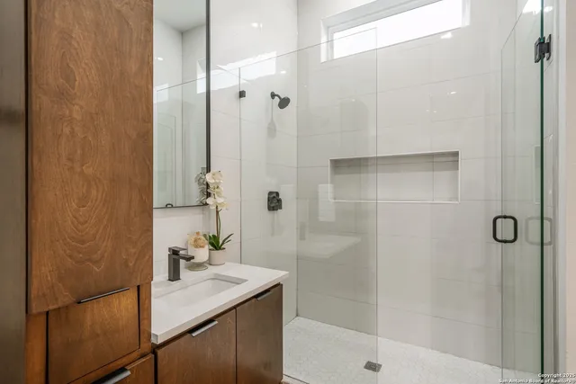 a bathroom with a shower and a sink