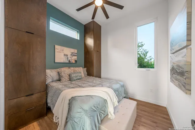 a bedroom with a bed and a painting on the wall