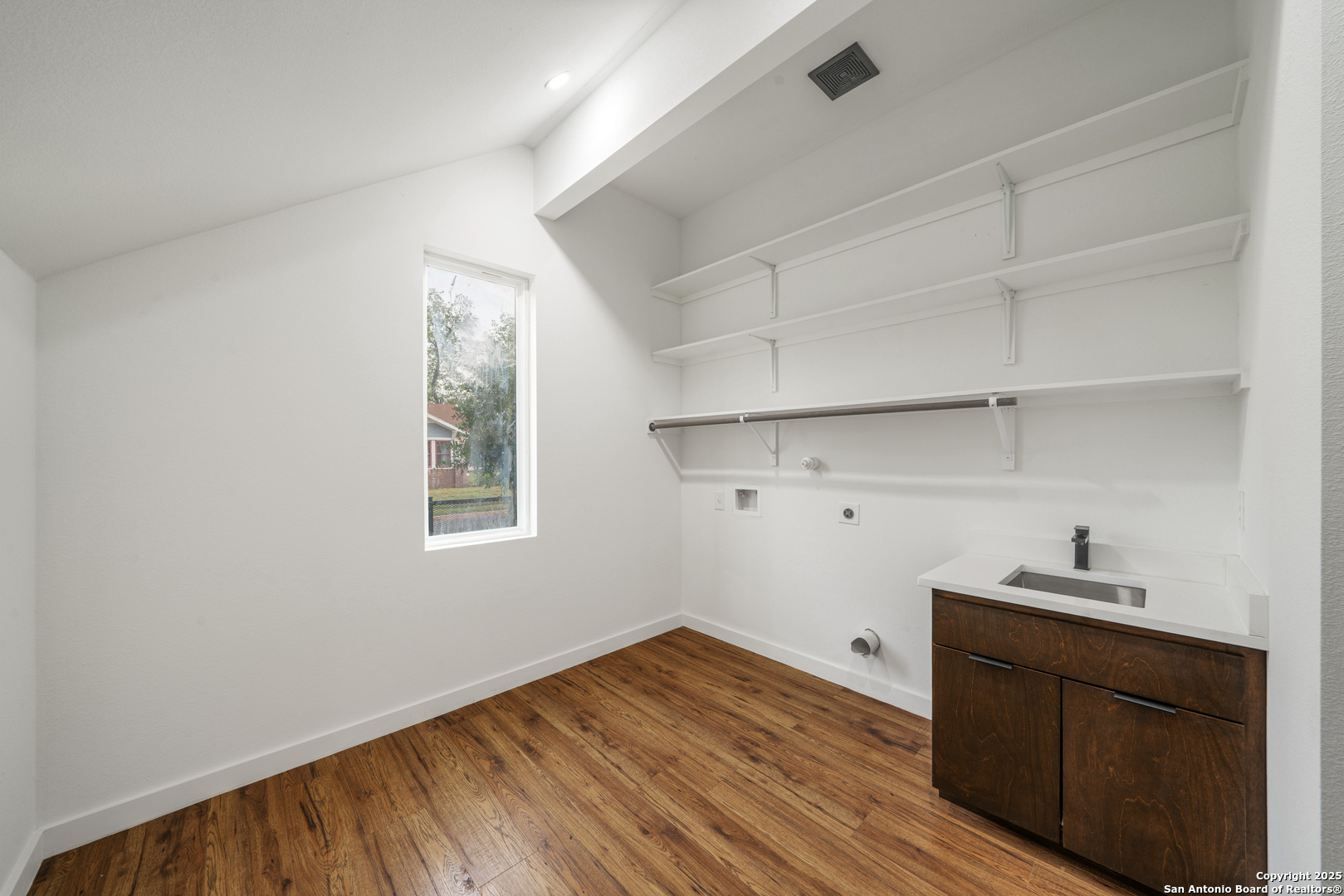 107 Harding Place, Unit 101 San Antonio, TX 78203 - Photo 25 of 39 a view of a closet area with wooden floor