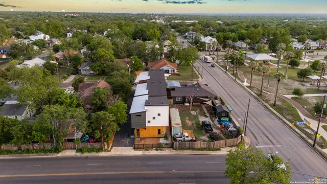 an aerial view of residential houses with outdoor space