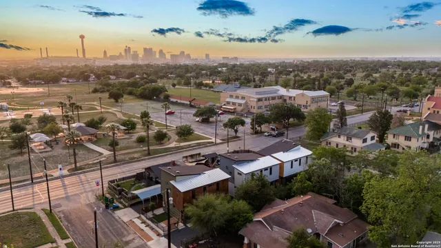 an aerial view of residential building with green space
