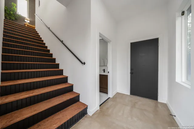 a view of entryway and hall with wooden floor