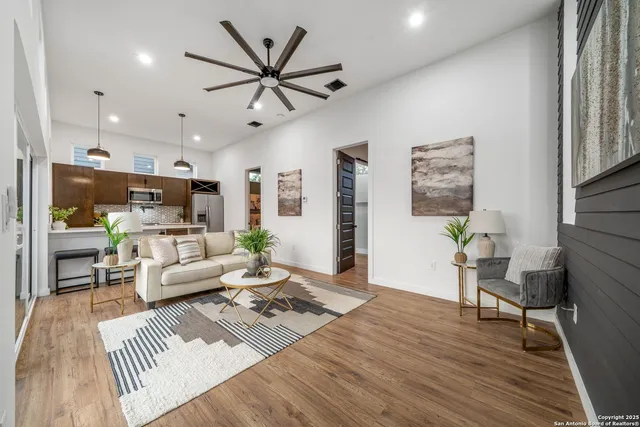 a living room with furniture and a wooden floor