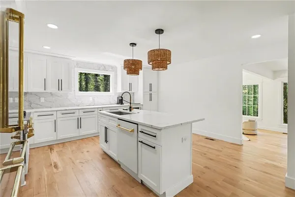 a kitchen with a sink stove and wooden cabinets