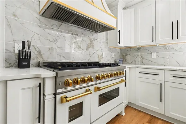 a stove top oven sitting inside of a kitchen