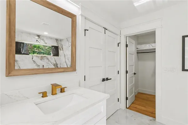a bathroom with a tub sink and mirror