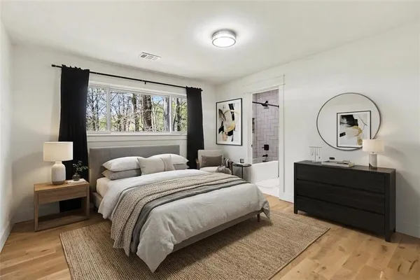a bedroom with a bed a mirror and a large window