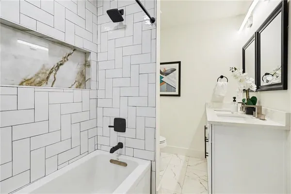a bathroom with a bathtub and sink