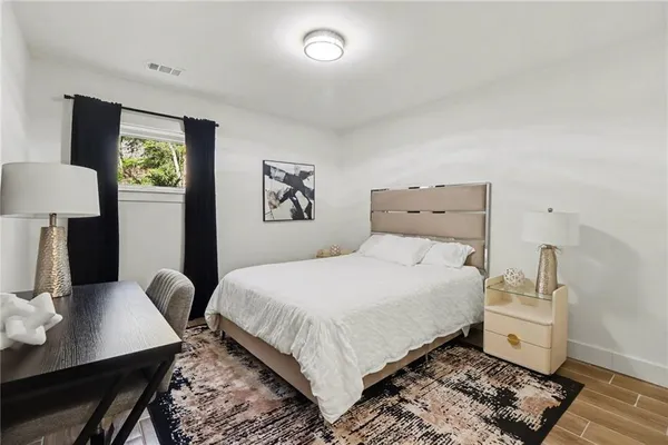 a bedroom with a bed and wooden floor