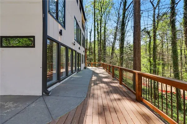 a view of balcony with wooden floor and fence